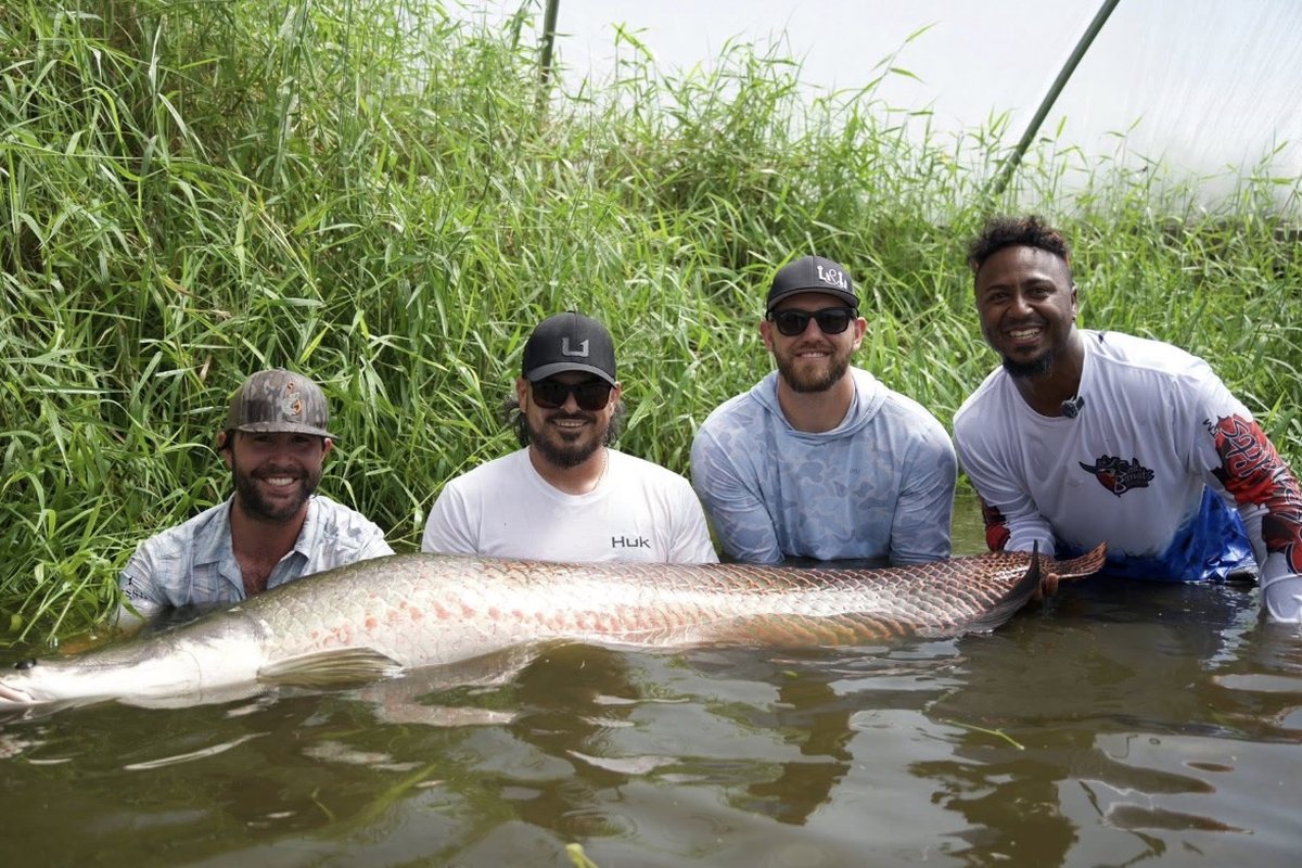 Hunter, James Marko, Ozzie Albies and Dylan Lee with a giant arapaima